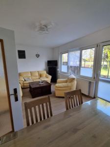 a living room with a couch and a table and chairs at Ferienhaus Am Zollhaus 