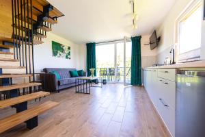 a kitchen and living room with a couch and a table at Okno na Jurę in Kroczyce