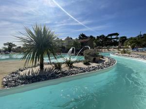 a pool at a resort with a water park at Camping Les Chouans in Saint-Hilaire-de-Riez