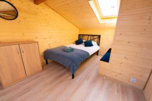 a bedroom with a bed in a wooden cabin at Okno na Jurę in Kroczyce