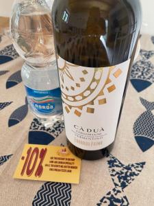 a bottle of wine sitting next to a glass at Da Pippo in Moneglia