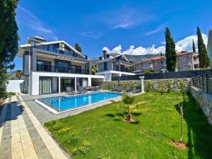 a house with a swimming pool and a yard at Nokta Life B Villa, Özel Havuzlu, Fethiye in Fethiye