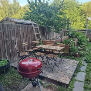 a backyard with a grill and a table and chairs at Town House by The Canals of Birmingham in Birmingham