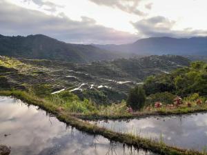 a view of a valley with a river and mountains at Vilma's Homestay in Bontoc