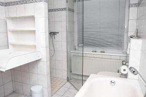 a bathroom with a shower and a toilet and a sink at Blaumeise in Bliesdorf