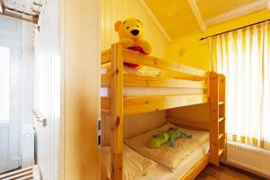 a teddy bear sitting on top of a bunk bed at Wellnesshaus Pappelhaus in Bliesdorf