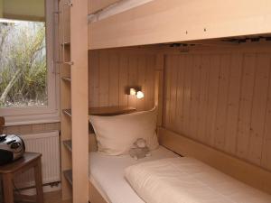 a teddy bear sitting on top of a bunk bed at Seeschwalbe in Bliesdorf