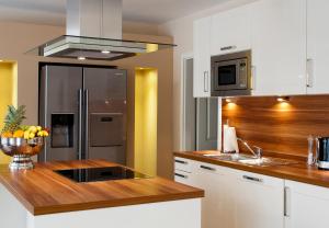 a kitchen with a stainless steel refrigerator and wooden counter top at Klabautermann in Grömitz
