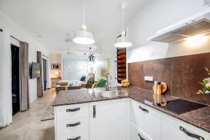 a kitchen with a sink and a counter top at Airlie Beach Eco Cabins - Adults Only in Airlie Beach