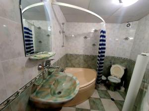a bathroom with a sink and a toilet at Family Hotel Paros 2 in Pomorie +25 photos