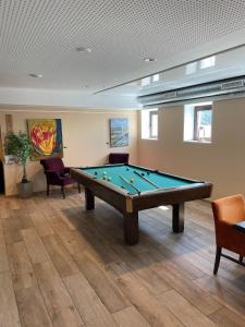 a billiard room with a pool table in it at Hotell Eikerapen Gjestegård Åseral in Åseral