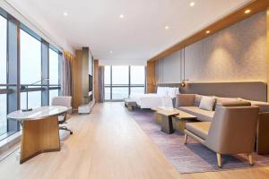 a hotel room with a couch and a bed at The Westin Zhongshan Guzhen in Zhongshan