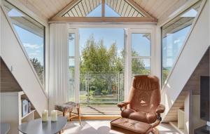 a living room with a chair in front of a window at Pet Friendly Home In Assens With House A Panoramic View in Assens