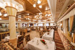 un ristorante con tavoli e sedie in una stanza di Hotel Auffacherhof a Wildschönau
