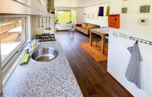 a kitchen with a sink in a tiny house at Nice stacaravan In Tzummarum With Wifi in Tzummarum