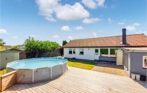 a backyard with a swimming pool and a house at Cozy Home In Helsingborg With Private Swimming Pool, Can Be Inside Or Outside in Helsingborg