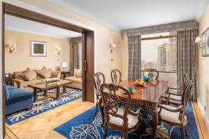 a living room with a table and a couch at Anjum Makkah Hotel in Mecca