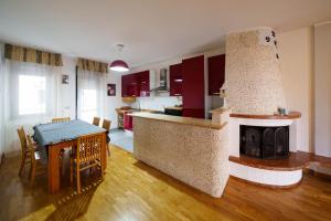 a kitchen and dining room with a table and a fireplace at B&B MELISSA in Silvi Marina