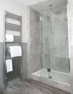 a bathroom with a shower with a glass shower stall at St Magnus House, Fabulous Harrogate town house in Harrogate