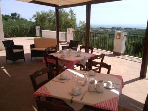 a restaurant with tables and chairs and a balcony at B&B Villa Makkalè in Vieste +6 photos