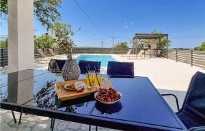 a table with a tray of fruit and drinks on it at 4 Bedroom Lovely Home In Miranje Gornje in Miranje Gornje