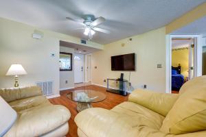 a living room with a couch and a tv at Florida Vacation Rental Condo Near Tampa in Lutz