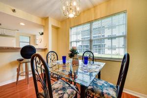 a dining room with a glass table and chairs at Florida Vacation Rental Condo Near Tampa in Lutz