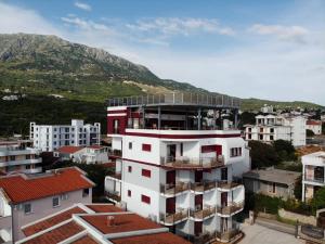 a view of a building with a mountain in the background at Compass Aparthotel in Dobra Voda