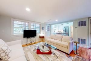 a living room with a white couch and a tv at Town of Rehoboth Beach 44 Henlopen Ave in Rehoboth Beach