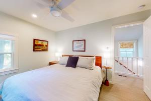 a bedroom with a large bed and two windows at Town of Rehoboth Beach 44 Henlopen Ave in Rehoboth Beach