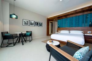 a bedroom with a bed and a table and chairs at Grand Hyatt Playa del Carmen Resort in Playa del Carmen