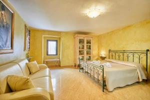 a bedroom with a bed and a couch at Centro Storico Rooms in Gallipoli +50 photos