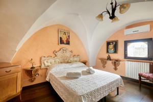 a bedroom with a bed with a white bedspread at Centro Storico Rooms in Gallipoli