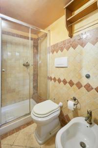 a bathroom with a toilet and a shower and a sink at Centro Storico Rooms in Gallipoli
