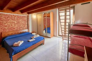 a bedroom with a bed and two bunk beds at Centro Storico Rooms in Gallipoli