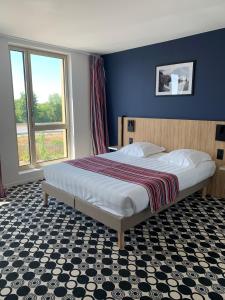 Cama o camas de una habitación en Akena Nantes Rezé Aéroport