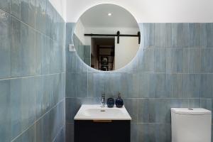 a bathroom with a sink and a mirror at Tiny Home in by Portimao Promenade Pier in Historic Quarter in Portimão