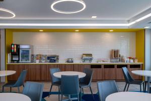 a waiting room with tables and chairs and a counter at Microtel Inn & Suites by Wyndham Winchester in Winchester