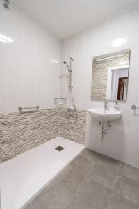 a bathroom with a sink and a shower at Pension O Camiño Milladoiro in Amés