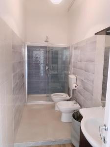a bathroom with a shower and a toilet and a sink at Brin home in La Spezia +21 photos