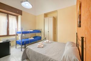 a bedroom with a bed with blue bunk beds at Centro Storico Rooms in Gallipoli +41 photos