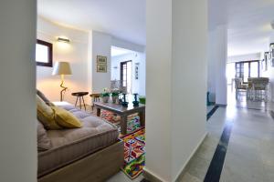 a living room with a couch and a table at Kalidon beach Hotel in Kokkari