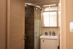 a bathroom with a sink and a toilet and a mirror at Plakoures Home in Kounoupidhianá +37 photos
