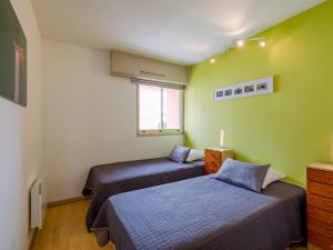 two beds in a room with green walls at Apartment Les Terres Marines by Interhome in Sainte-Maxime