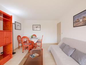 a living room with a couch and a table at Apartment Les Terres Marines by Interhome in Sainte-Maxime