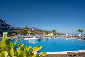 una grande piscina con sedie e l'oceano sullo sfondo di Cosy flat with sea views in Santa Ursula a Santa Úrsula