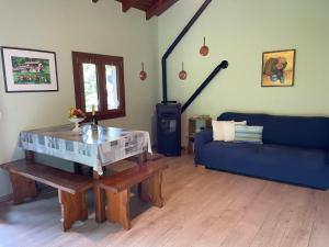 a living room with a blue couch and a table at Chalet Baita Lavu' by Interhome in Trarego