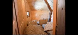 a small room with two chairs and a couch at Koča Velika Planina - Chalet Kamrica in Stahovica