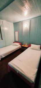 two beds in a room with blue walls at Hotel Golden Sea in Vama Veche