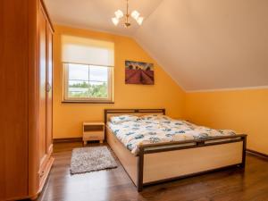 a bedroom with a bed and a window at Holiday Home Villa von Valdi by Interhome in Władysławowo